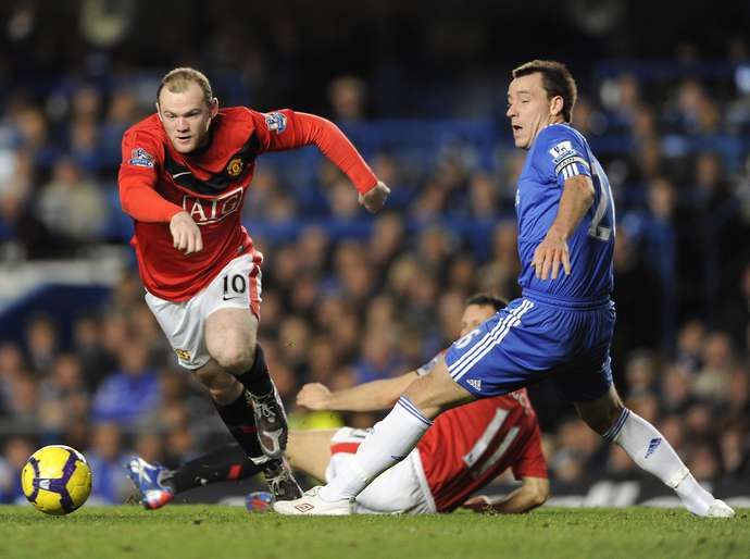 Wayne Rooney takes the ball past John Terry