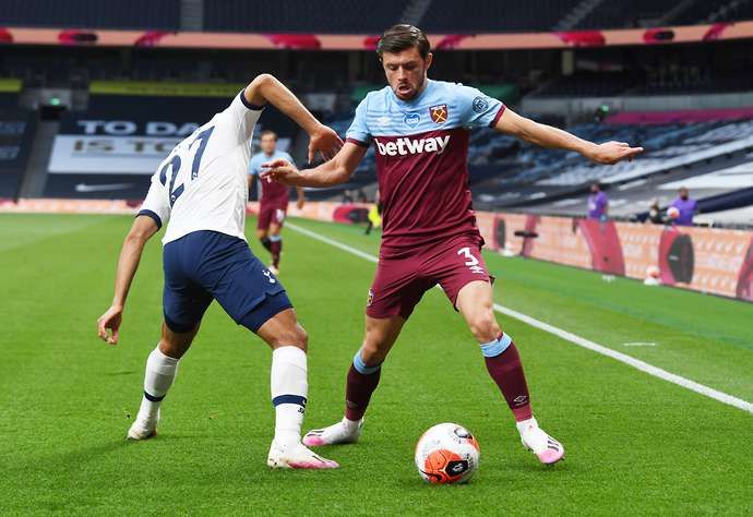 Aaron Cresswell takes the ball past Lucas Moura