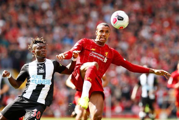 Joel Matip challenges for the ball