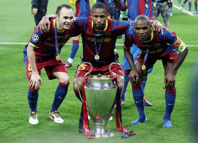 Barcelona's Andres Iniesta, Seydou Keita and Eric Abidal with the Champions League trophy
