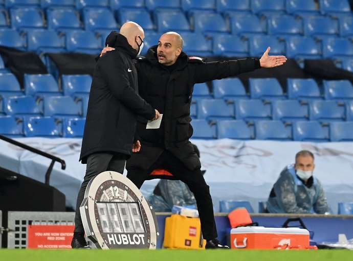 Pep Guardiola and Anthony Taylor