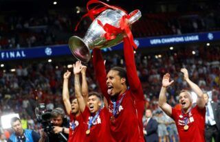 Liverpool's Virgil van Dijk lifts the Champions League trophy