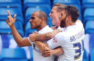Former Leeds midfielder Rodolph Austin celebrates with his teammates