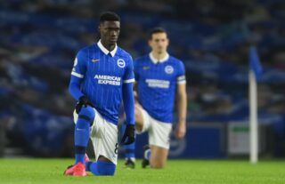 Brighton midfielder Yves Bissouma takes a knee