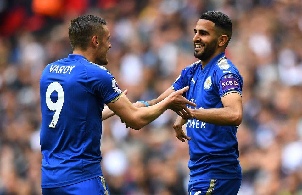 Riyad Mahrez celebrates with Jamie Vardy while playing for Leicester City
