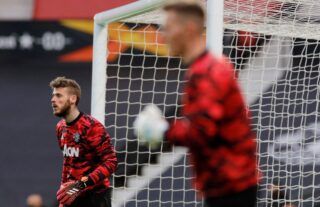 Manchester United goalkeeper David De Gea warms up alongside Dean Henderson at Old Trafford before playing AS Roma