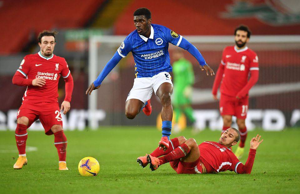 Brighton midfielder Yves Bissouma is tackled by Liverpool's Thiago in a Premier League game at Anfield