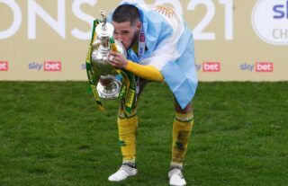 Norwich winger and Aston Villa target Emiliano Buendia kissing the Championship trophy