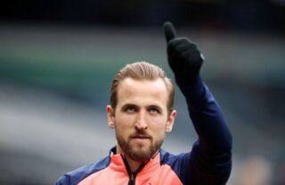 Tottenham striker Harry Kane gives the thumbs-up to someone in the stands