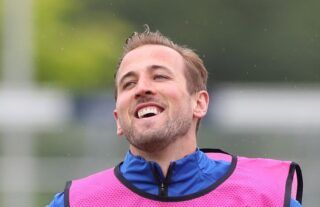 Tottenham striker and Man City target Harry Kane looking happy in training