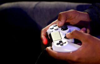 White PS4 controller being held