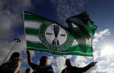 Fans holding up a Celtic flag ahead of a clash with Rangers