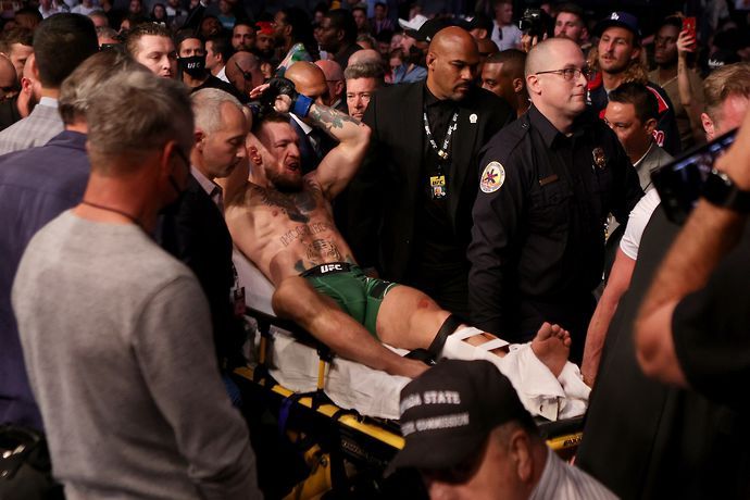 Conor McGregor is carried out of the cage on a stretcher