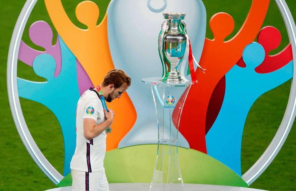 England captain Harry Kane walks past the trophy at Euro 2020