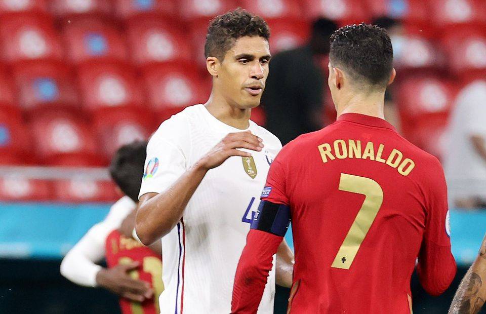 Raphael Varane shakes hands with Cristiano Ronaldo during Euro 2020