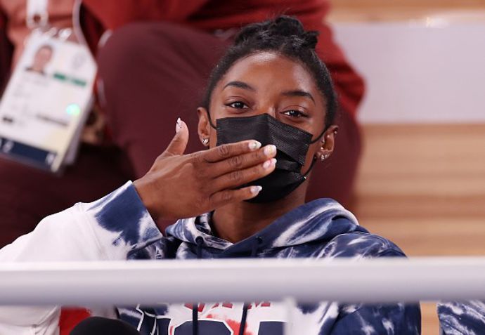 Simone Biles of Team United States blows a kiss whilst watching the Men's All-Around Final on day five of the Tokyo 2020 Olympic Games at Ariake Gymnastics Centre on July 28, 2021 in Tokyo, Japan. (Ph