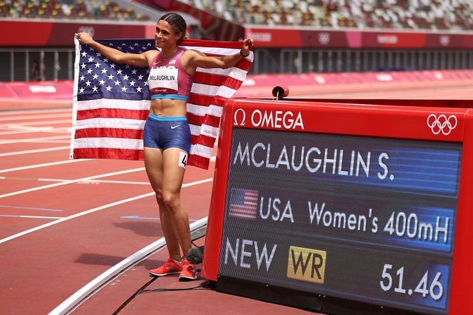Sydney McLaughlin poses next to world record