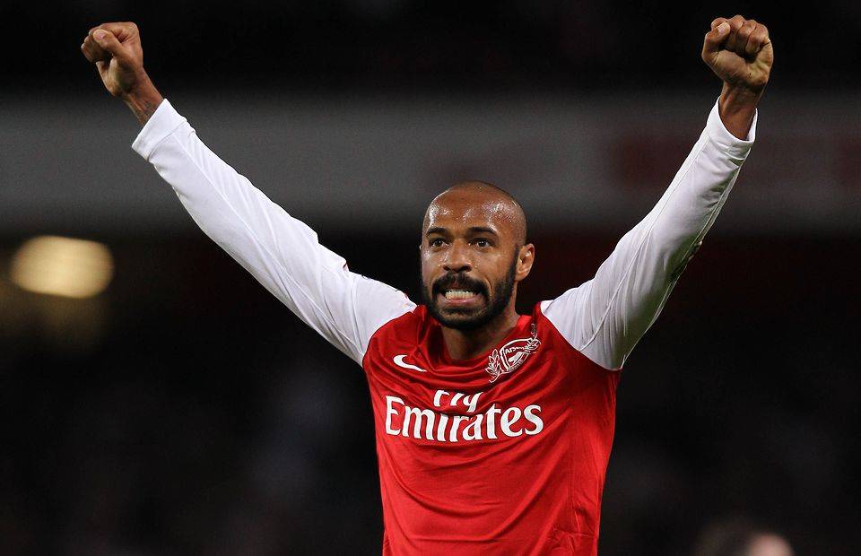 Thierry Henery raising his arms aloft in celebration for Arsenal