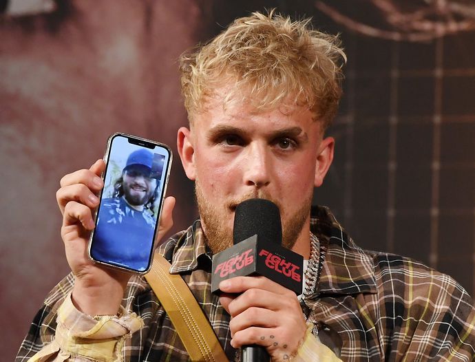 Jake Paul talks to mixed martial artist Jorge Masvidal on his cell phone during a news conference for Triller Fight Club's inaugural 2021 boxing event at The Venetian Las Vegas on March 26, 2021 in La