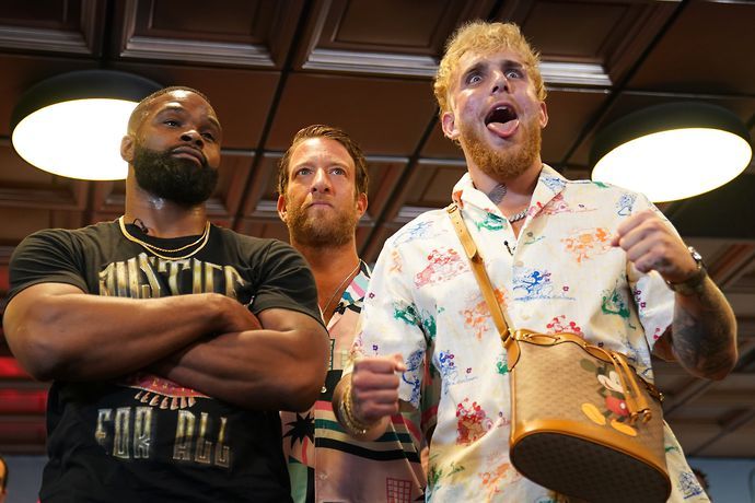 Jake Paul and Tyron Woodley stand side by side at promotion event