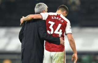 Former Tottenham manager Jose Mourinho embraces Arsenal midfielder Granit Xhaka