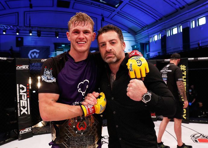 Ian Garry celebrates after beating Jack Grant to win the Cage Warriors welterweight title