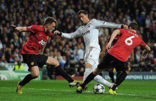 Phil Jones and Cristiano Ronaldo during Real Madrid vs Man Utd in 2013