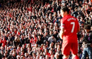 Luis Suarez prepares to take a corner for Liverpool at Anfield