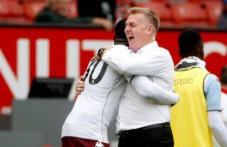 Aston Villa manager Dean Smith celebrating with Kortney Hause at Old Trafford
