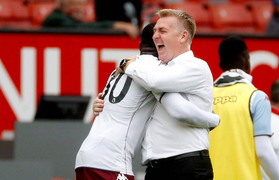 Aston Villa manager Dean Smith celebrating with Kortney Hause at Old Trafford