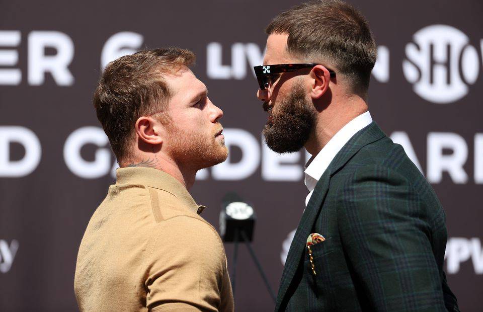 Canelo Alvarez faces off with Caleb Plant during their pre-fight press conference.