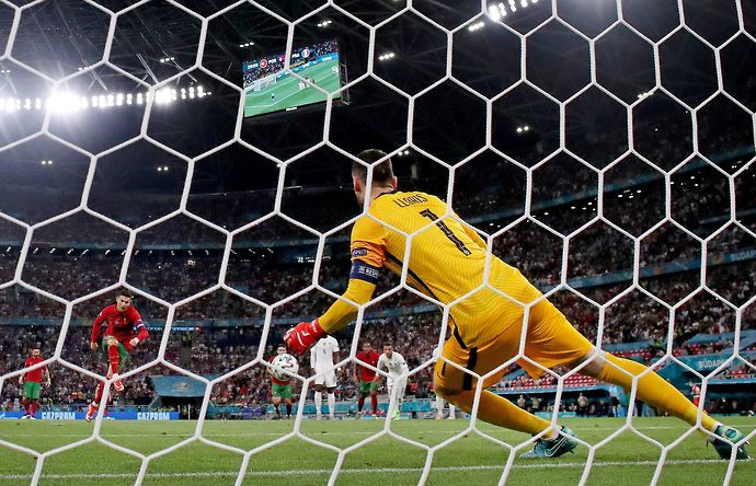 Cristiano Ronaldo of Portugal scores his sides first goal past Hugo Lloris if France from the penalty spot during the UEFA Euro 2020 Championship Group F match