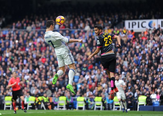 Cristiano Ronaldo of Real Madrid heads the ball past Diego Antonio Reyes of RCD Espanyol