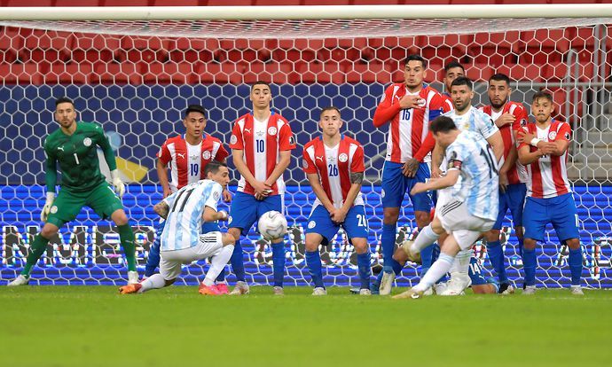 Lionel Messi of Argentina shoots a free kick during a group A match between Argentina and Paraguay