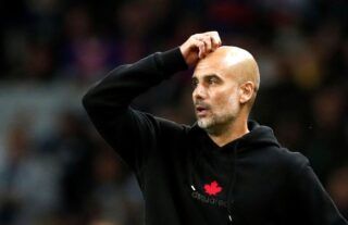 Man City manager Pep Guardiola scratching his head