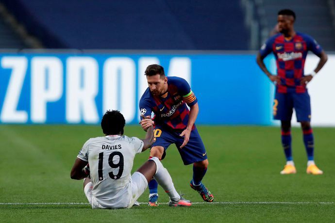 Alphonso Davies and Lionel Messi in action during Bayern vs Barcelona