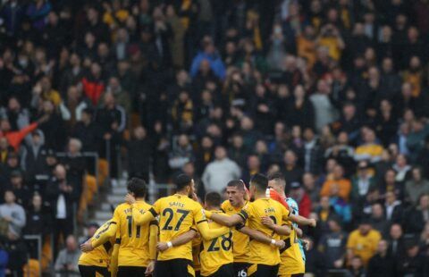 Wolves players in a huddle in front of the Molineux crowd