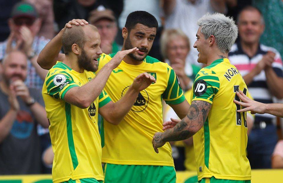 Norwich City trio Teemu Pukki, Ozan Kabak and Mathias Normann celebrate a goal at Carrow Road