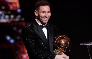 Lionel Messi with the 2021 Ballon d'Or trophy
