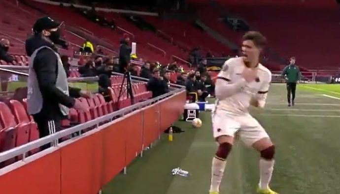 Riccardo Calafiori reacts to being hit by a ball flung at him by a ball boy during Ajax v Roma