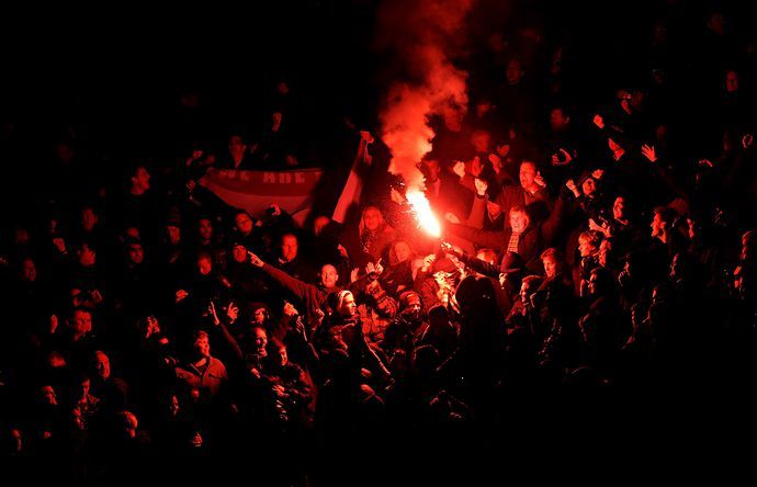Football fans and a flare.