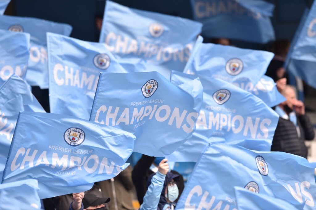 Manchester City fans hold up flags before the match