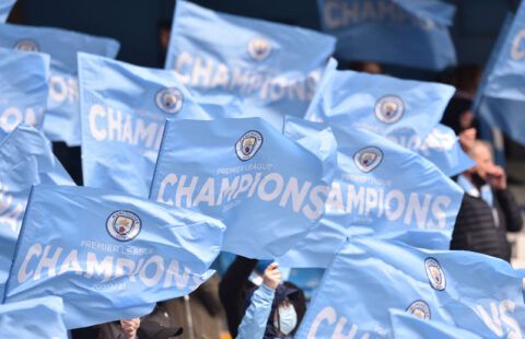 Manchester City fans hold up flags before the match