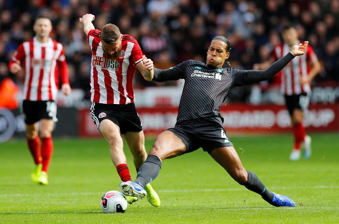 Oli McBurnie and Virgil van Dijk in action during Sheffield United vs Liverpool