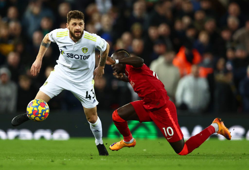 Mateusz Klich of Leeds United battles for possession with Sadio Mane of Liverpool during the Premier League match between Liverpool and Leeds United