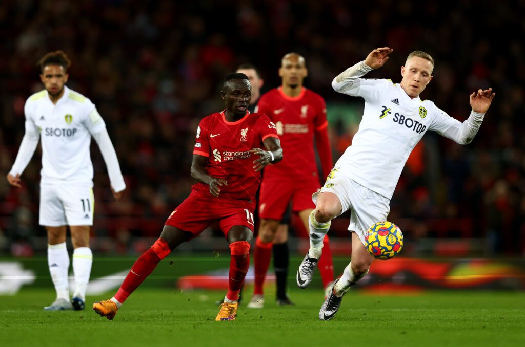 Adam Forshaw of Leeds United in action with Sadio Mane of Liverpool during the Premier League match between Liverpool and Leeds United