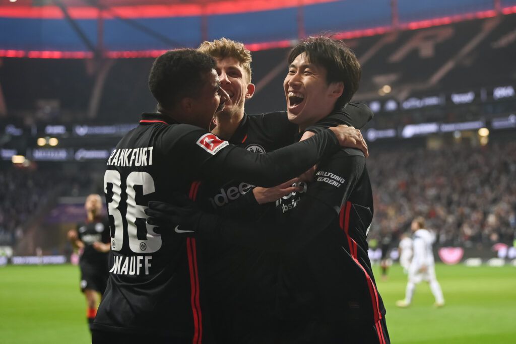 Daichi Kamada of Eintracht Frankfurt celebrates after scoring his team`s second goal with Jesper Lindstroem of Eintracht Frankfurt and Ansgar Knauff