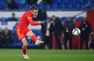 Gareth Bale of Wales hits a free-kick that eventually leads to a goal