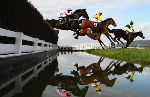 Horses jump over water at Cheltenham Festival Day Two