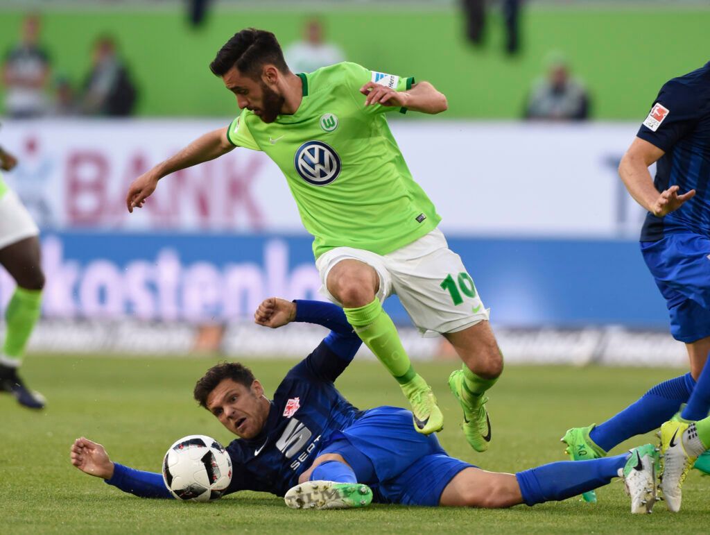 Malli is tackled at Wolfsburg.